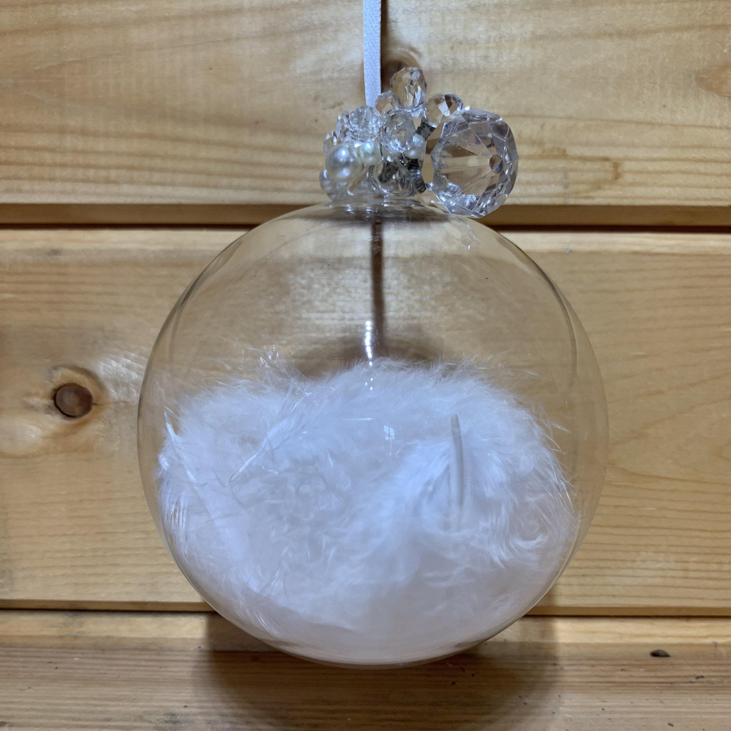 Lovely large clear round bauble shaped glass hanging Christmas decoration with a white feather inside and delicate beading on the top.