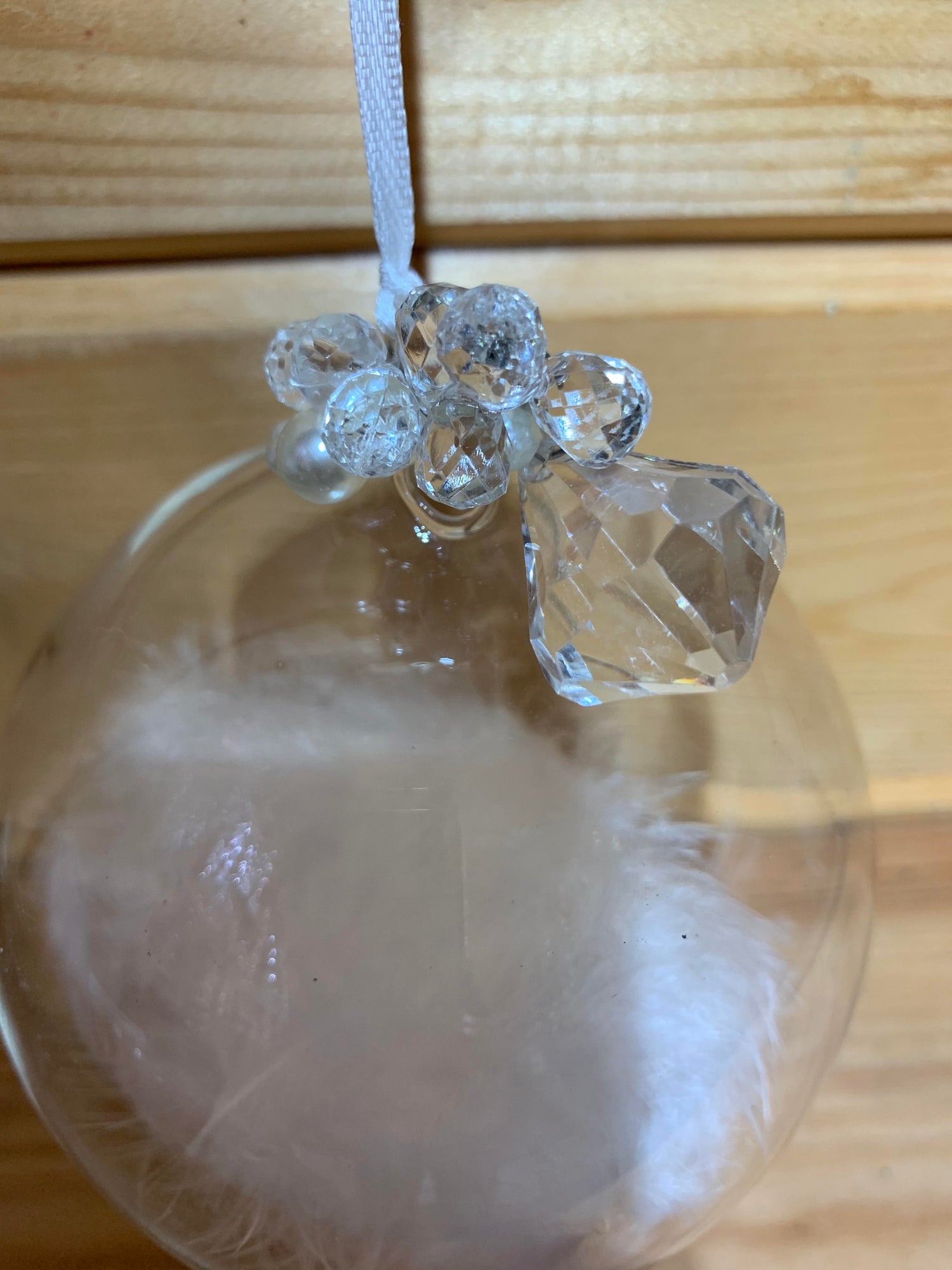 Lovely large clear round bauble shaped glass hanging Christmas decoration with a white feather inside and delicate beading on the top.