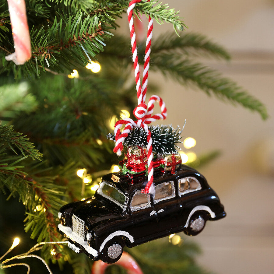 Bring a touch of the big city to the tree with this very cool London black cab carrying a Christmas tree.