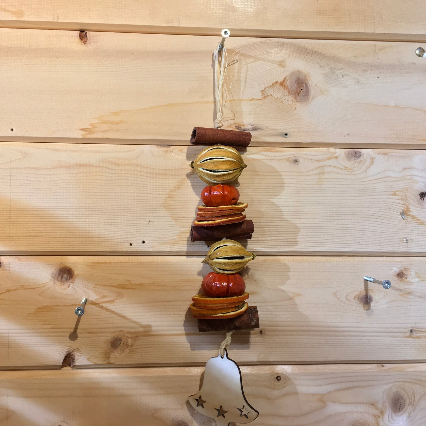 Deliciously fragrant lemon and orange hanging garland with a wooden bell decoration.