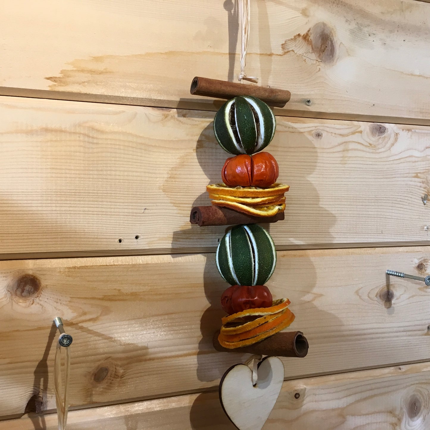 Deliciously fragrant lime and orange hanging garland with a wooden heart decoration.