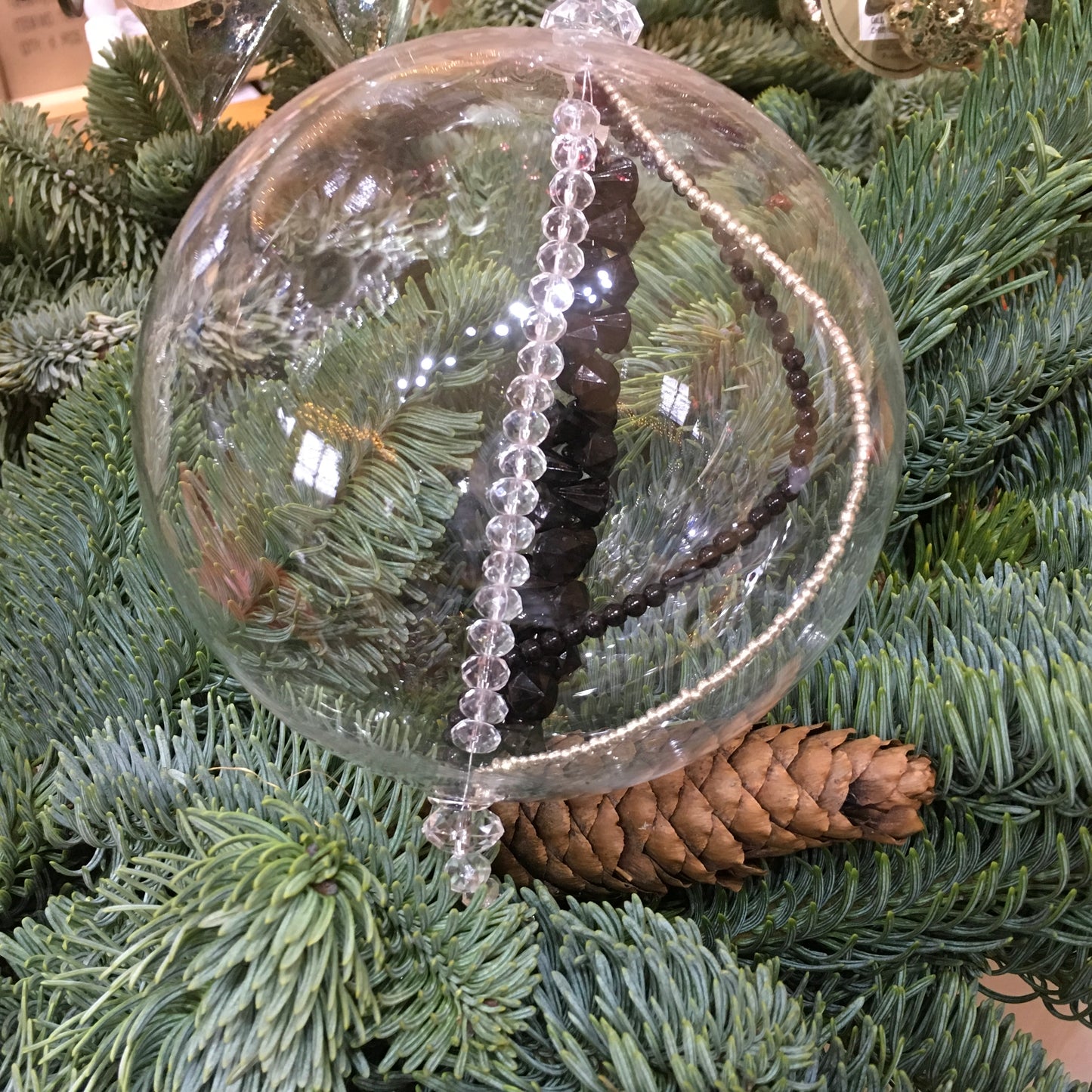 Handmade blown glass sphere filled with strings of black, clear and silver beads