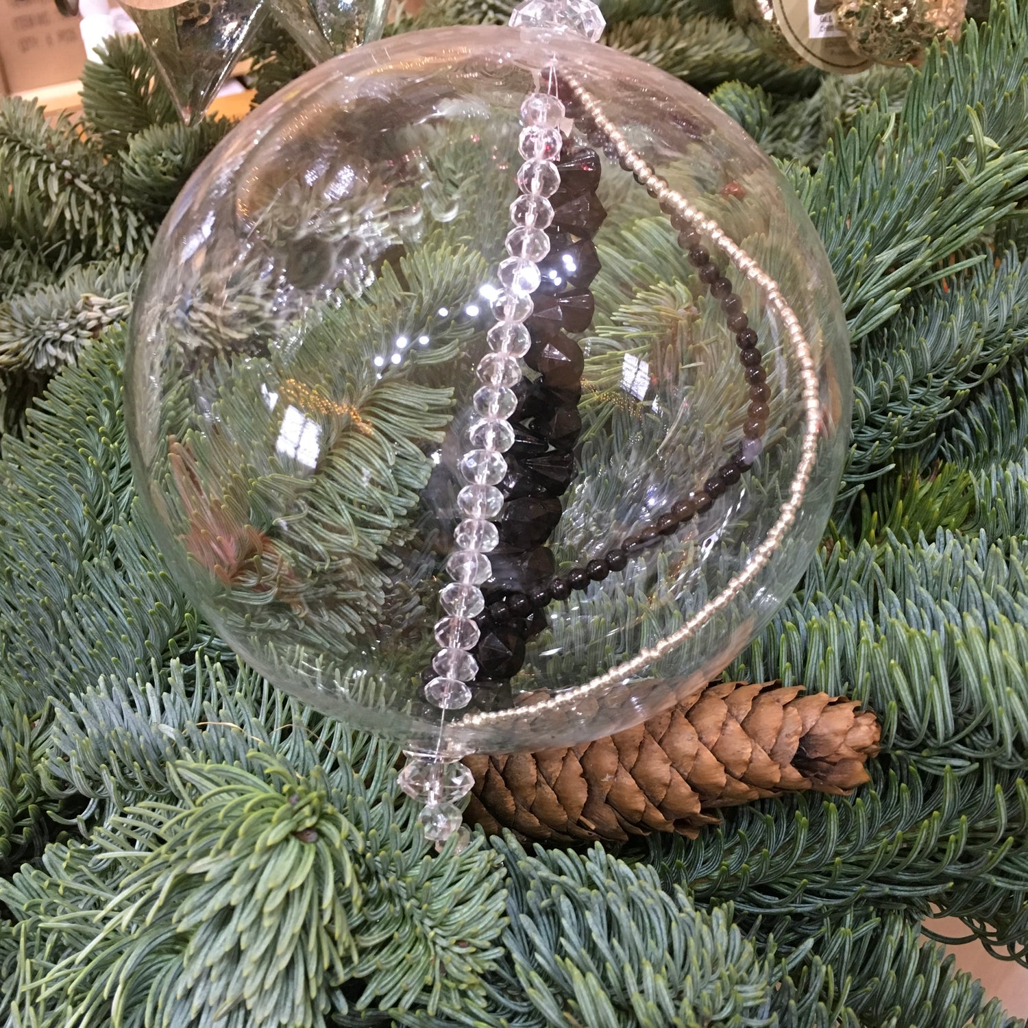 Handmade blown glass sphere filled with strings of black, clear and silver beads