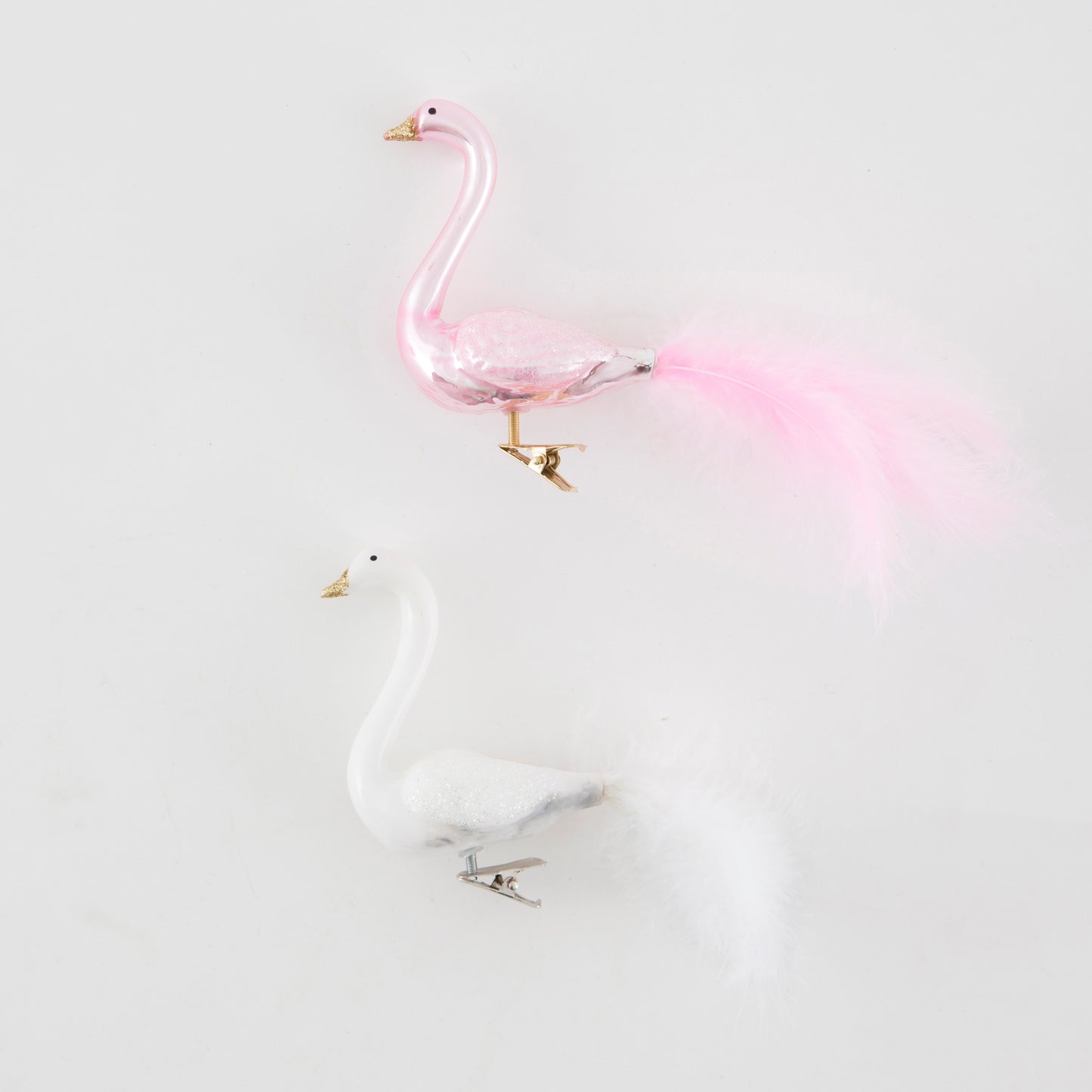 Glass Pink flamingo with gold beak, and glittery wings with real tail feathers, this clip bobs around on a tree.