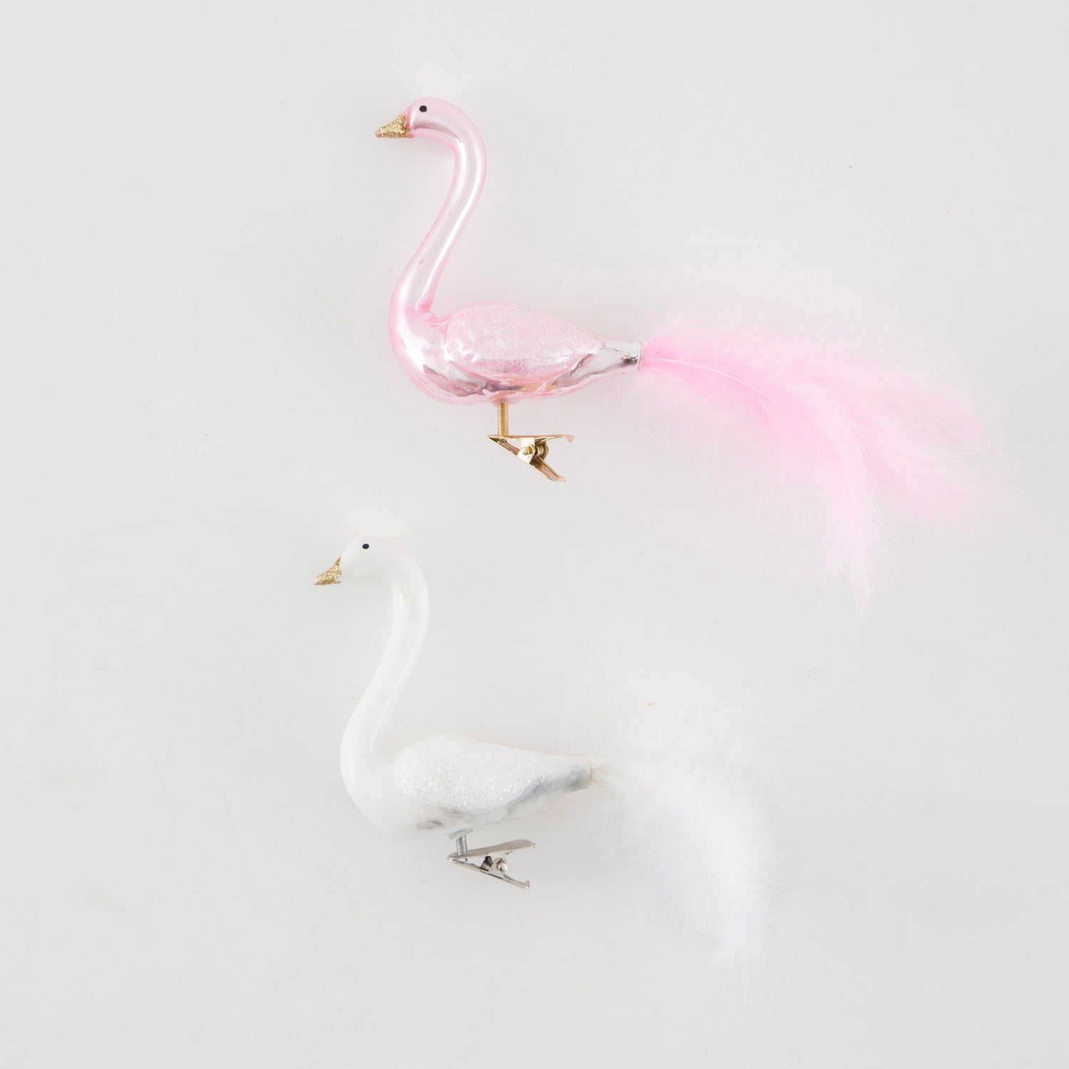 Glass Pink flamingo with gold beak, and glittery wings with real tail feathers, this clip bobs around on a tree.