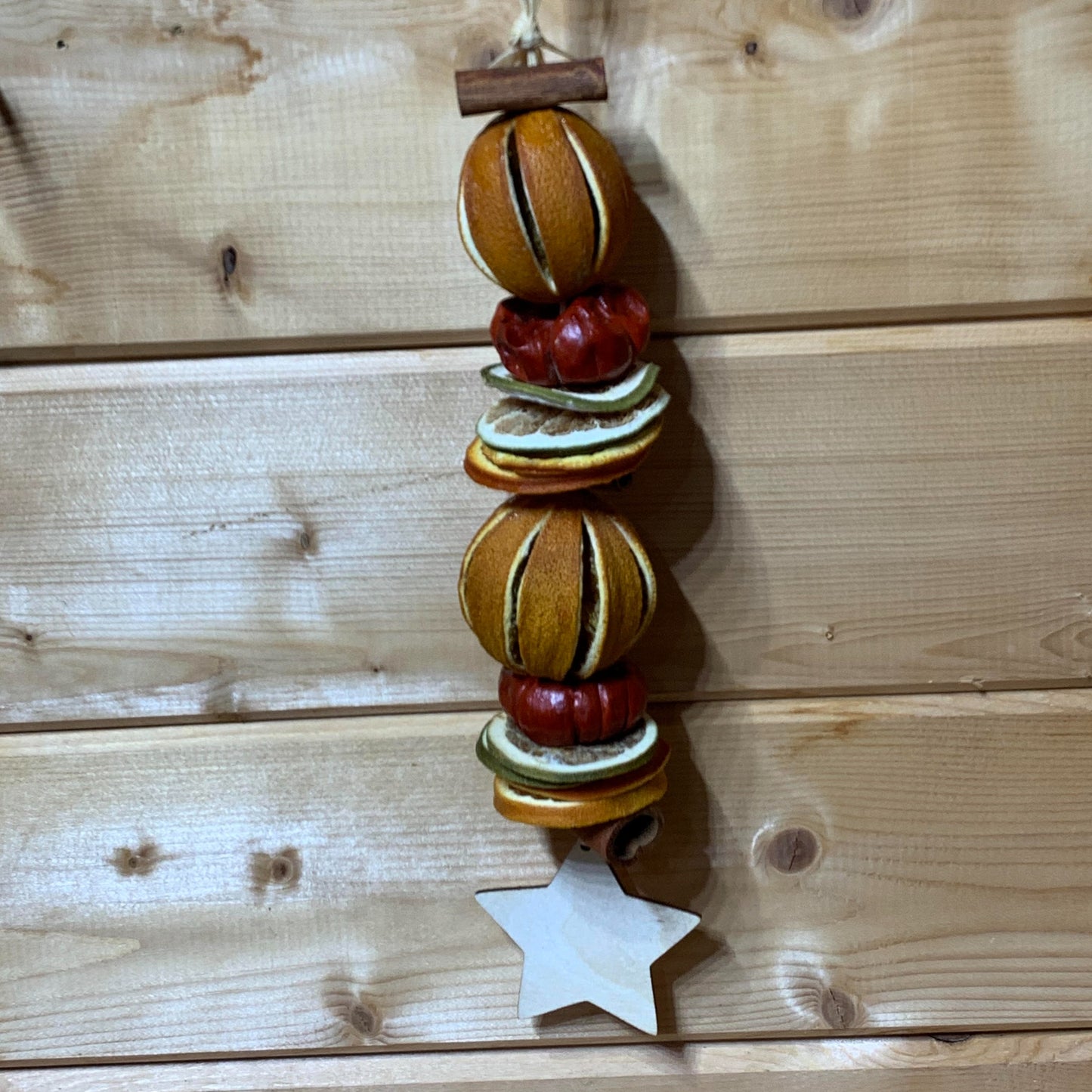 Deliciously fragrant orange and lime hanging garland with a wooden star decoration.