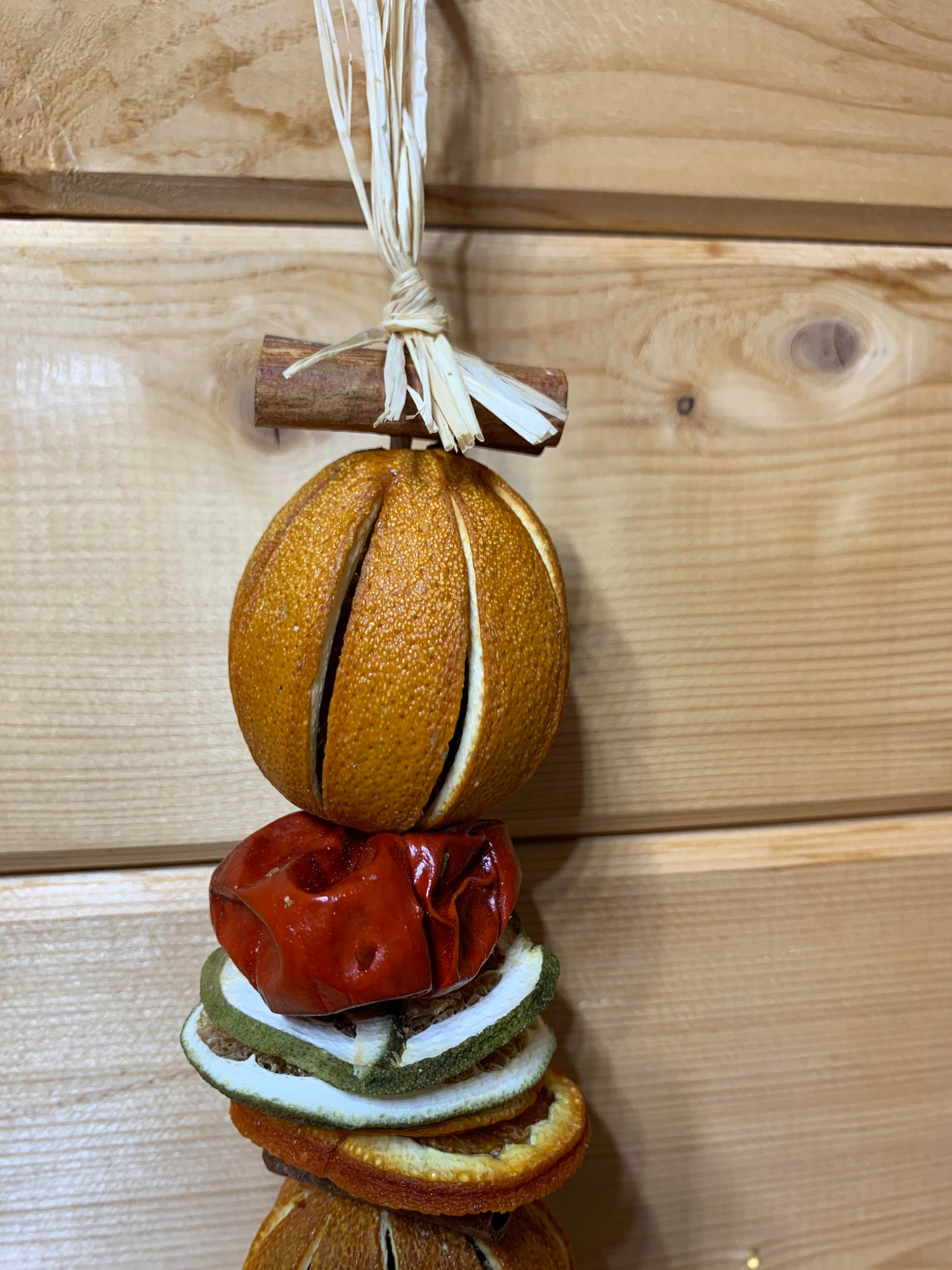 Deliciously fragrant orange and lime hanging garland with a wooden star decoration.