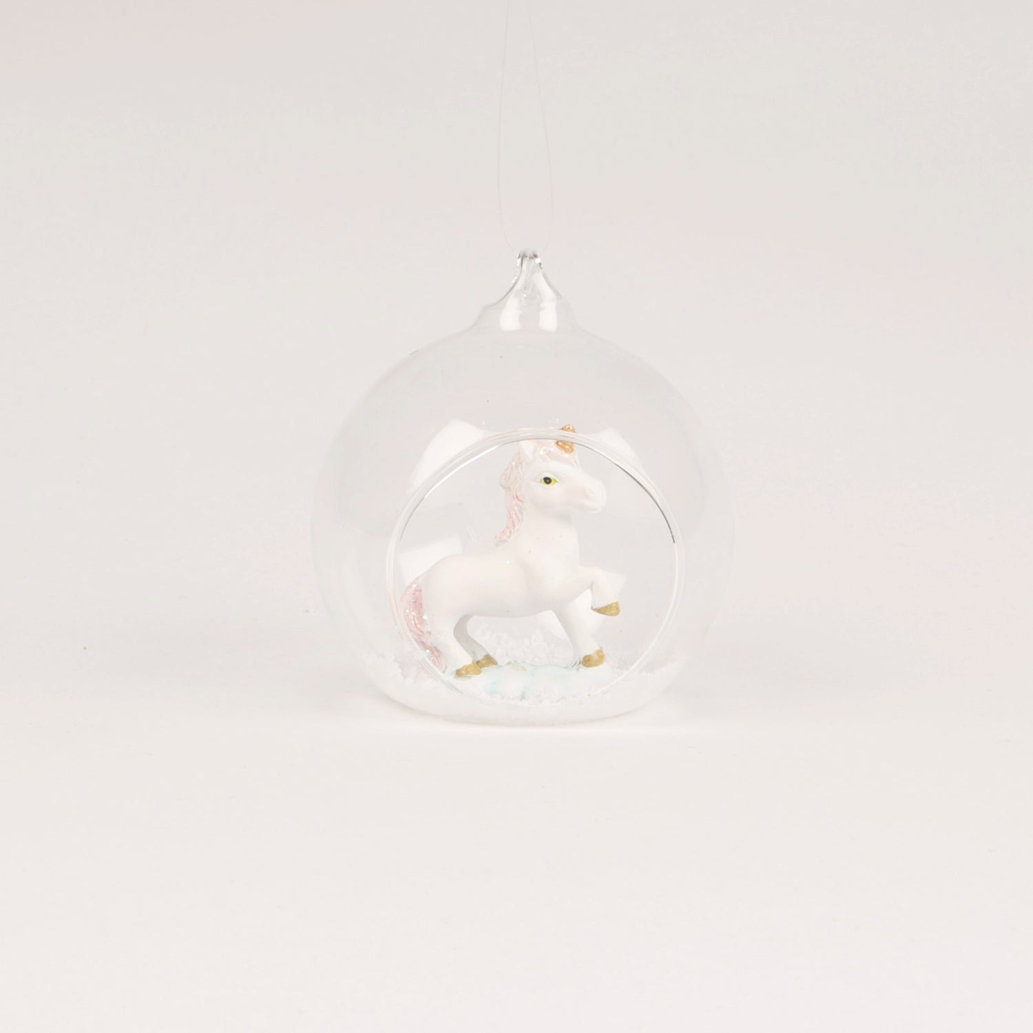 A beautiful open glass bauble Christmas tree decoration, with a glittery unicorn inside.