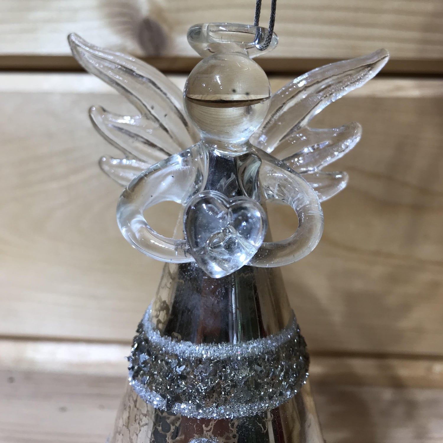 This stunning glass antique effect angel holding a heart, decorated with beading in a floral design, will be the perfect finishing touch to your Christmas tree!