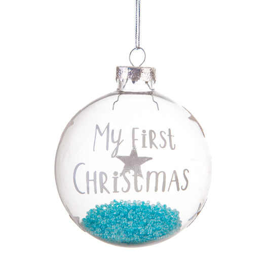 Clear glass sphere decoration with blue beads inside and 'My First Christmas' printed on the side.