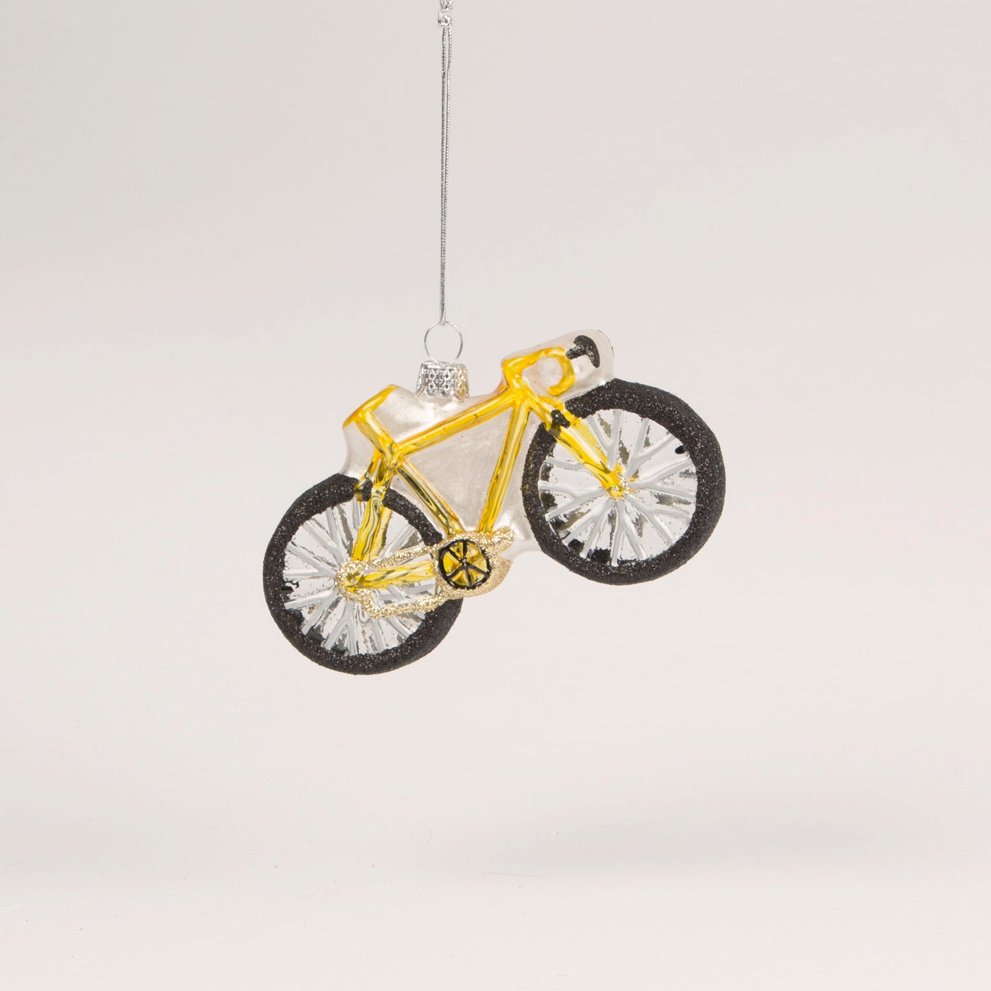 A gold bicycle Christmas decoration to be hung on your tree or in your home.
