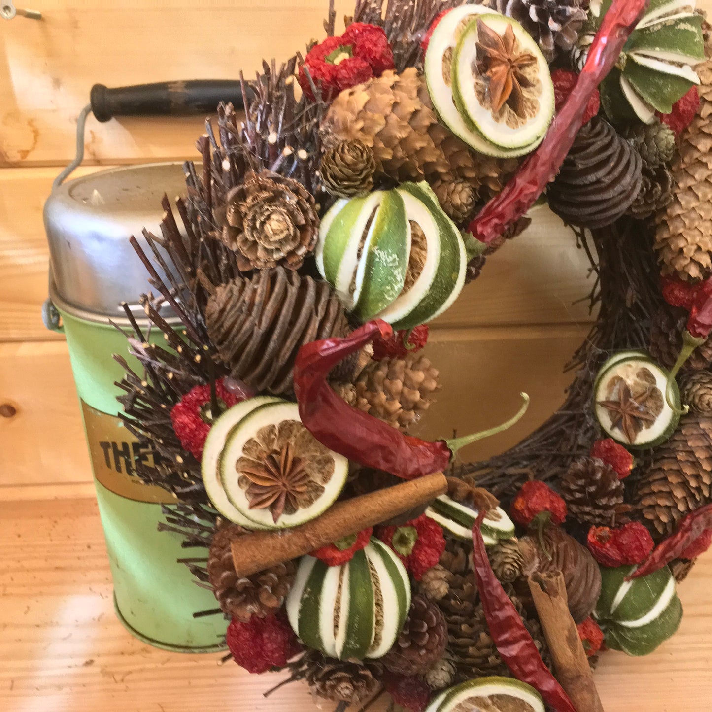 Red and green festive wreath made from dried lines and peppers for  Christmas