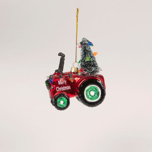 Red and green tractor with a Christmas Tree and lights, and 'Merry Christmas' written on the side.