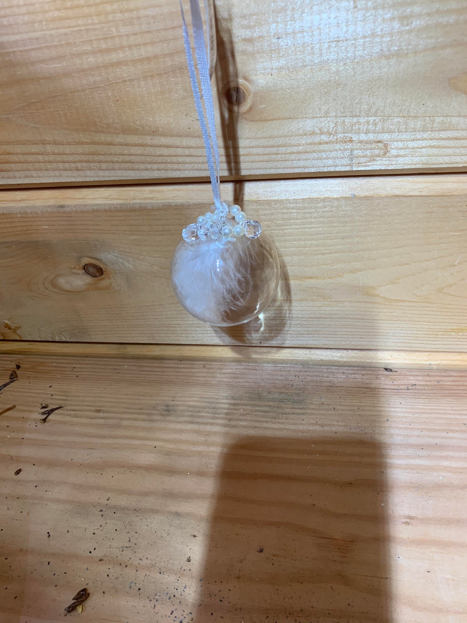 Lovely clear round bauble shaped glass hanging Christmas decoration with a white feather inside and delicate beading on the top.