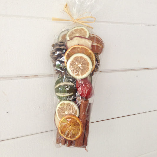 Bag of dried Christmas oranges, limes, chillies, cones and cinnamon for wreath decoration or pot pourri.