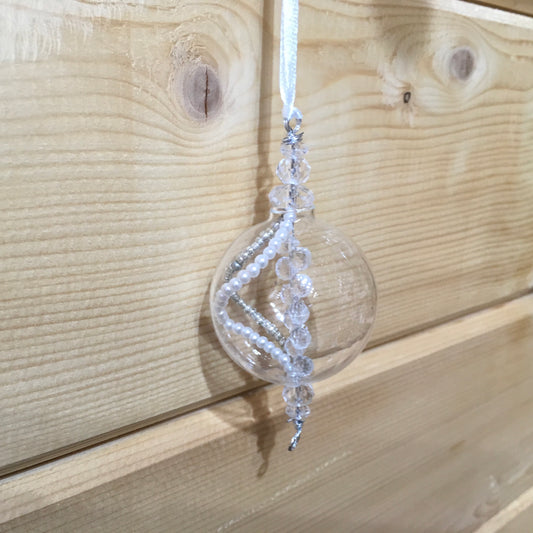 Delicate clear glass decoration with sparkling strings of clear and pearl beads