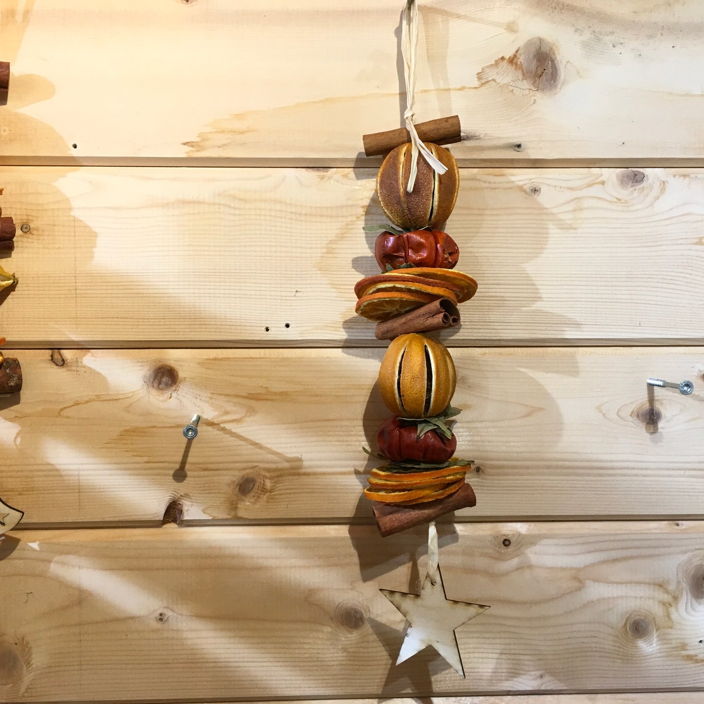 Deliciously fragrant orange and cinnamon hanging garland with a wooden star decoration.