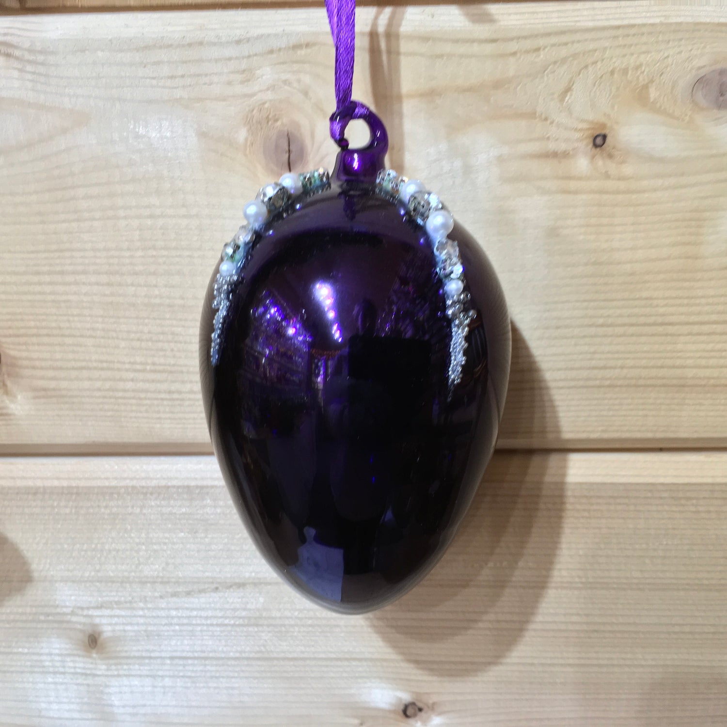 This shiny purple egg shape Christmas ornament is made from glass and decorated with beads, pearls and diamonte.