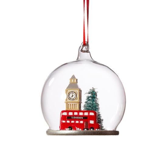 It doesn't really get any more magical than this!! Reminisce of those times gone by with this magical London City scene snow dome glass Christmas tree decoration: featuring Big Ben, a classic red London bus and a gorgeous Christmas tree all covered in snow!