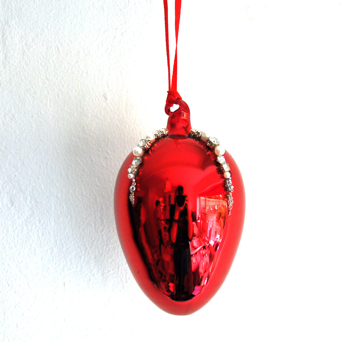 This red mirror egg shape Christmas ornament is made from glass and decorated with beads, pearls and diamonte.