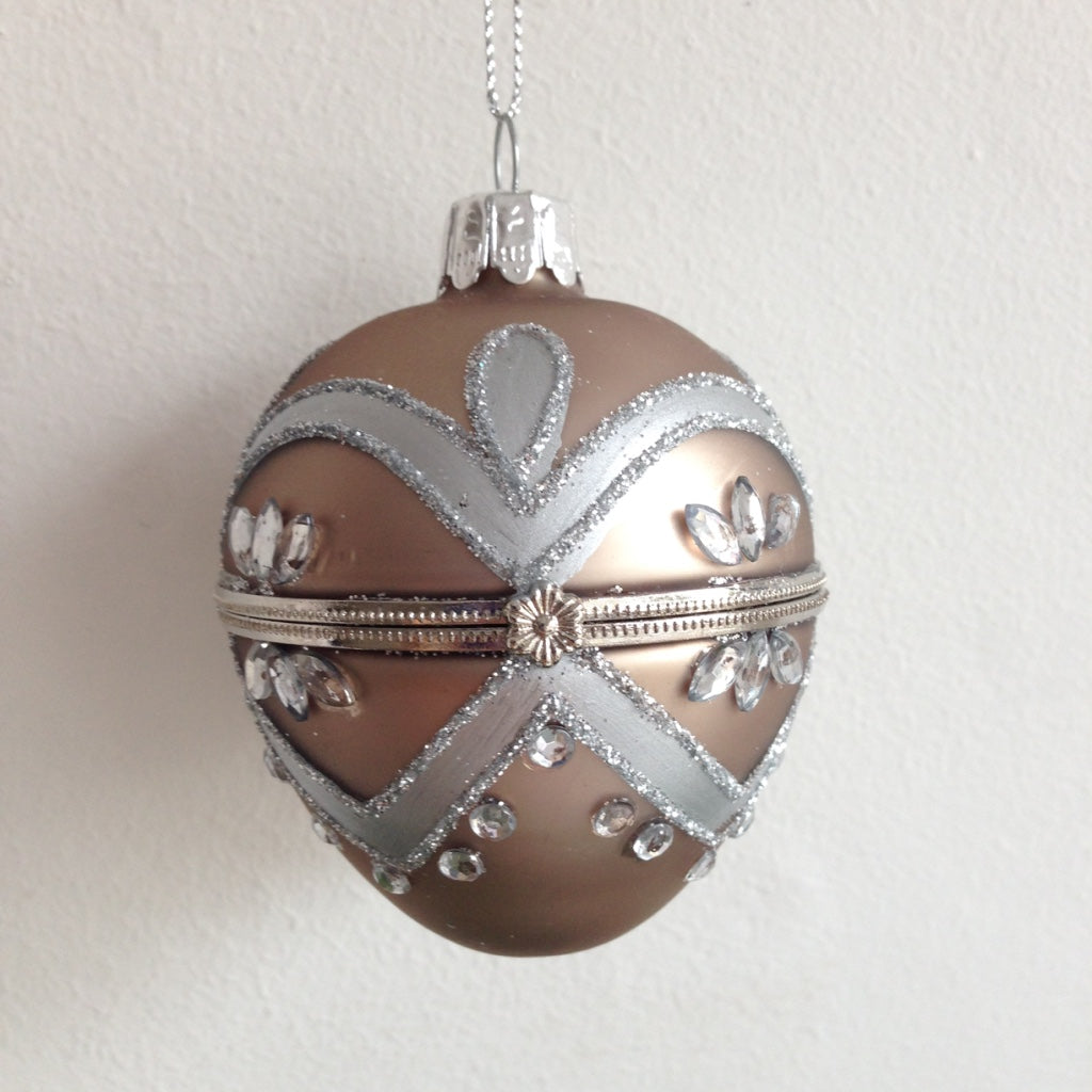 Metallic silver egg shaped glass ornament for christmas tree hanging decoration, opens up so you can store gift inside.