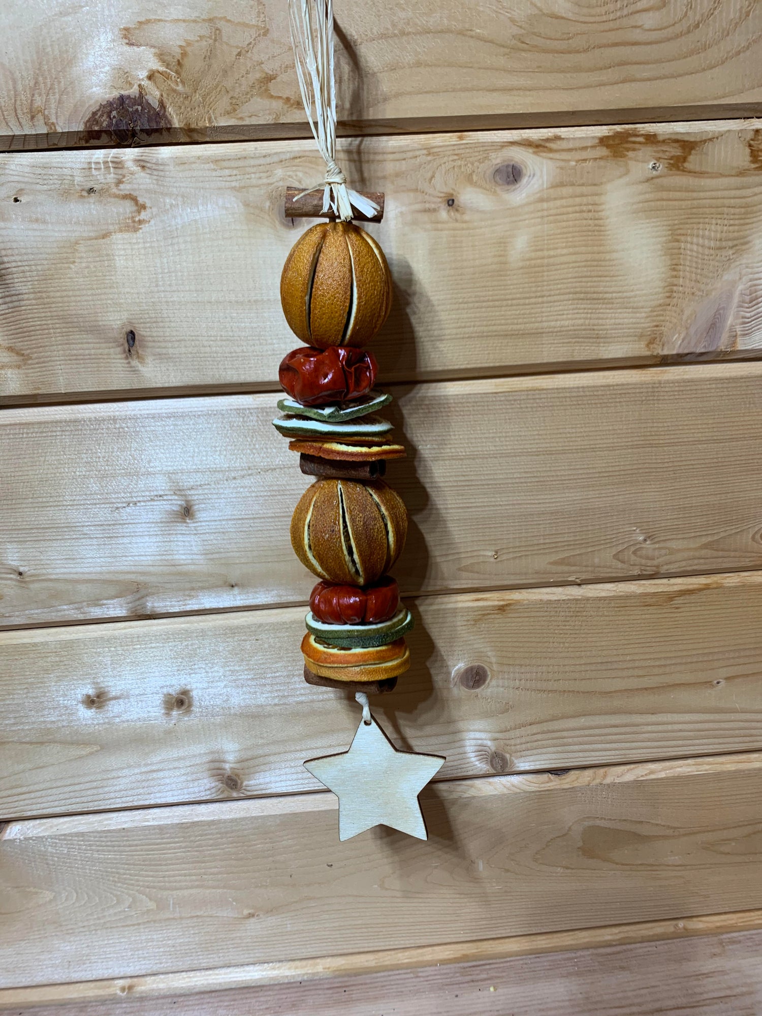 Deliciously fragrant orange and lime hanging garland with a wooden star decoration.