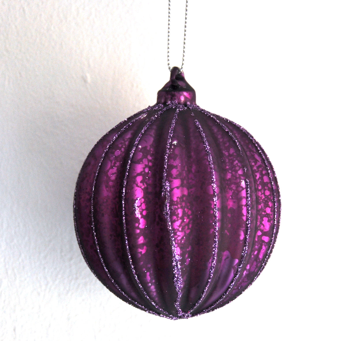 This glittery aubergine purple ridged Christmas bauble is made from glass.