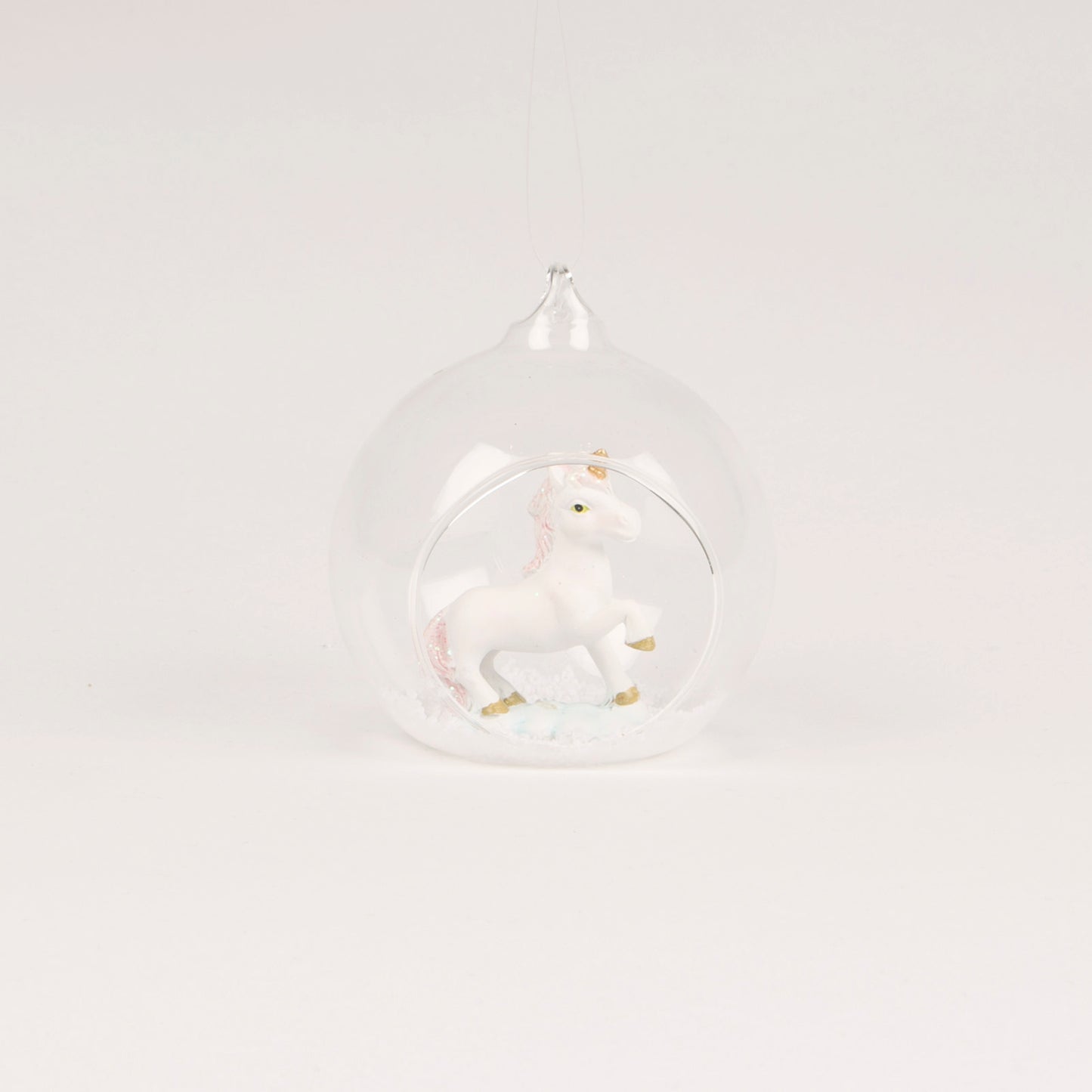 A beautiful open glass bauble Christmas tree decoration, with a glittery unicorn inside.